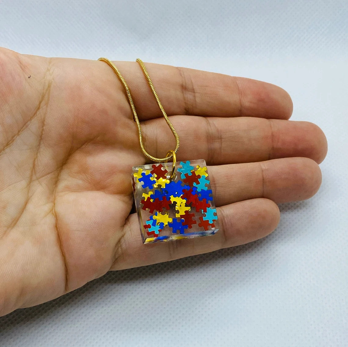 Puzzle Piece Resin Pendant-Autism Awareness jewelry, Square Pendant with 18" long gold-colored chain, Primary Colors